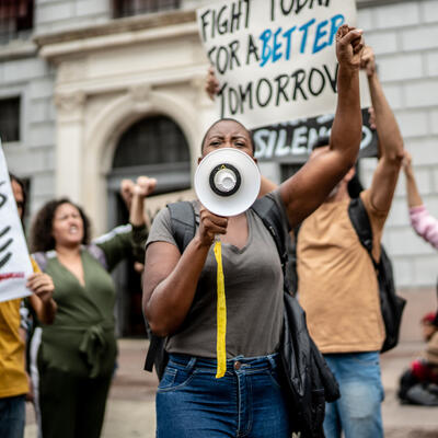 A woman holds a megaphone at a protest