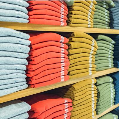 Folded shirts line a store's shelves