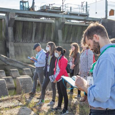 Thriving Earth scientists examine a bridge