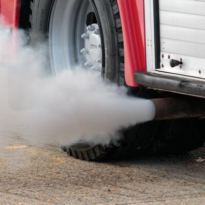 Emissions billow out of a truck's exhaust pipe