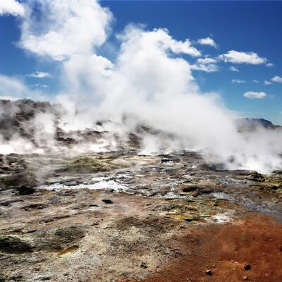 Image of steam rising over geothermal field