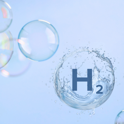 bubbles floating in the air with one bubble that is popping, and has the text "H2" inside of it