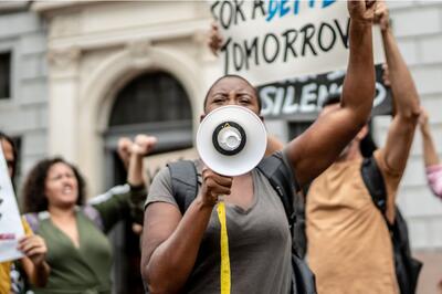 A woman holds a megaphone at a protest